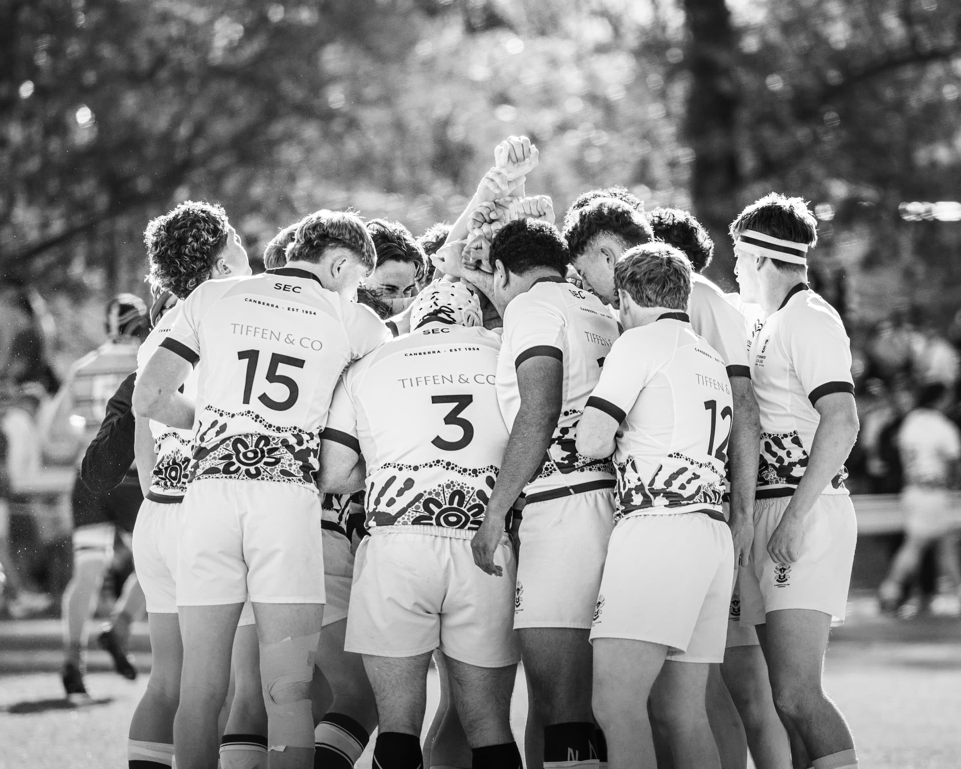 Rugby team gathered in a pre-game huddle