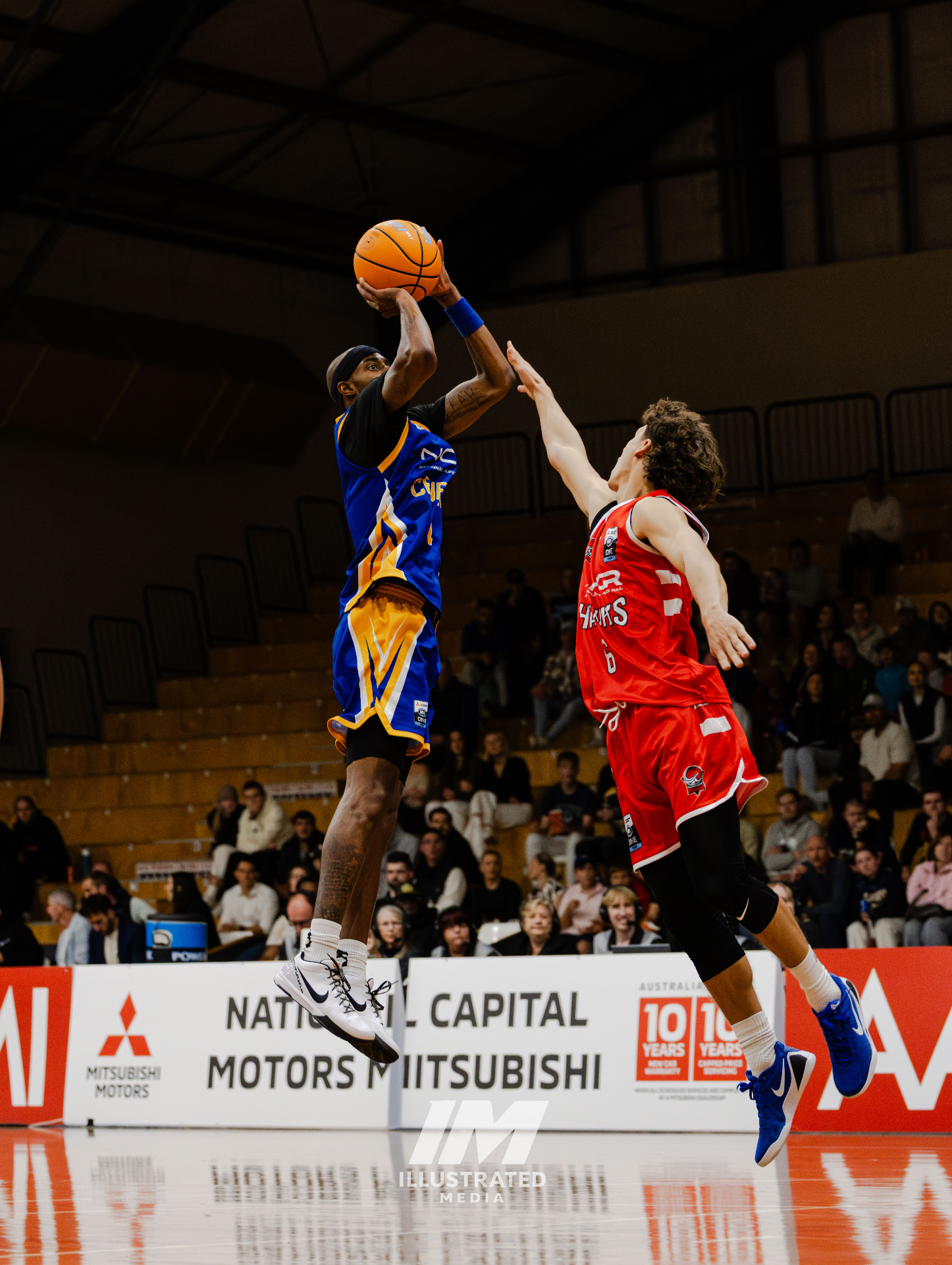Basketball player mid-dunk in dramatic lighting